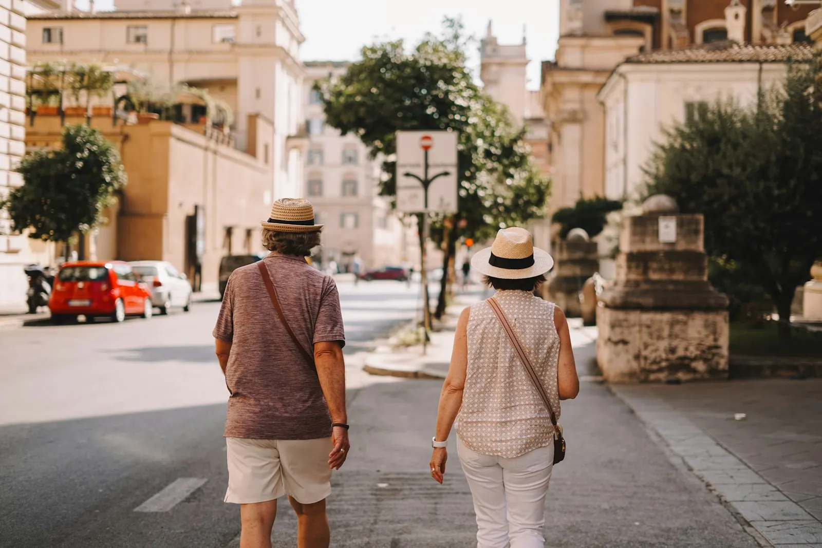 A couple strolling a sunlit street in Italy