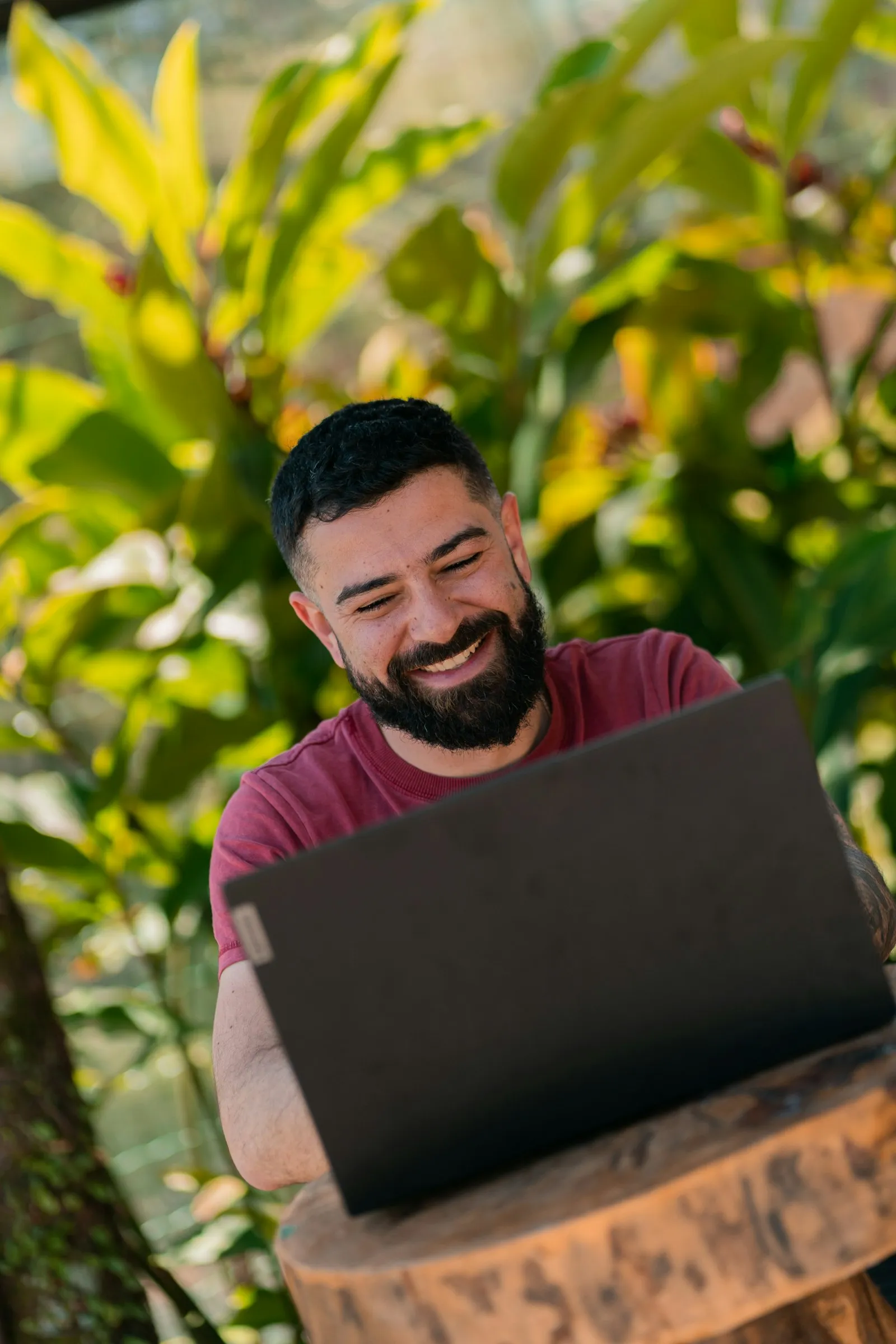 An investor smiling at his portfolio from a leafy patio